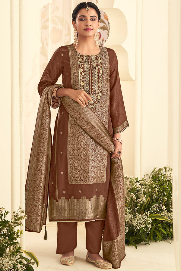 Woman in traditional brown and beige outfit with floral decorations